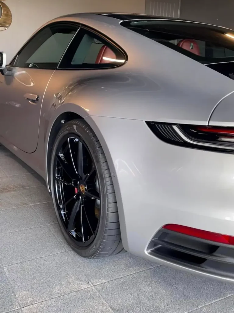 Silver Porsche 911 rear quarter panel with deep gloss finish and black wheels after exterior detailing by Pure Auto-Care